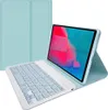 A light blue tablet case with an attached keyboard is shown in a studio setting against a white background. The tablet is open and propped up by the case, displaying a colorful abstract wallpaper. The keyboard is white with light blue keys. Náhled obrázku produktu