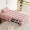 A pink upholstered sofa bed is displayed in a room, with a pillow at one end. Anteprima dell’immagine prodotto