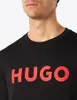 Close-up of a man wearing a black t-shirt with a red HUGO logo. Produktbild-Vorschau
