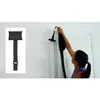 A woman is using a TRX suspension trainer attached to a door. Produktbild-Vorschau
