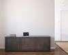 A weather station is displayed on a dark cabinet in a hallway. Produktbild-Vorschau
