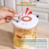 A hand is shown operating the lid of a fermentation jar filled with pickled vegetables. Náhľad obrázku produktu
