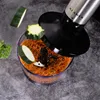 A close-up shot of a food chopper with chopped carrots and zucchini inside, and some zucchini slices falling into it. Produktbild-Vorschau