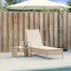 A lounge chair and small table are set up on a patio next to a pool, under a large umbrella. Produktbild-Vorschau