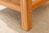 Close-up of a wooden table leg on a textured rug. Produktbild-Vorschau