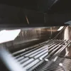Close-up view inside a stainless steel grill. Náhľad obrázku produktu