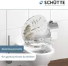 A toilet seat with a decorative design is shown on a toilet in a bathroom setting. Náhled obrázku produktu