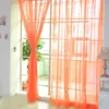 A sheer orange curtain is draped across a window, with a lamp visible on the right side. Produktbild-Vorschau
