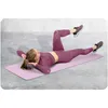 A woman is doing abdominal exercises on a yoga mat. Anteprima dell’immagine prodotto