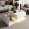 A modern living room scene featuring a white high-gloss coffee table with LED lighting, a sofa, and a side table. Produktbild-Vorschau