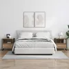 A bedroom scene with a bed and two nightstands. Produktbild-Vorschau