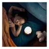 A child sleeping next to a night light. Produktbild-Vorschau