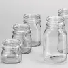 A group of clear glass jars with wire bail closures are arranged on a light gray background. Produktbild-Vorschau