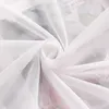 A close-up of white sheer fabric, likely a curtain, with a floral pattern subtly visible underneath. Produktbild-Vorschau