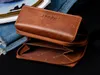 An open brown leather wallet is shown on a black surface, with denim jeans and a book in the background. Náhľad obrázku produktu