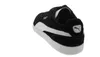 A black Puma sneaker with a white stripe and sole, shown from the back-right. Podgląd zdjęcia produktu