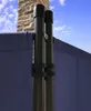 A close-up view of a blue fabric screen attached to dark poles, with a brick chimney and blue sky in the background. Produktbild-Vorschau