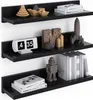 Three black floating shelves mounted on a white wall, decorated with various items. Náhľad obrázku produktu