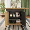 A kitchen island with storage, featuring a microwave and various kitchen items, set in a well-lit room with a window and curtains. Podgląd zdjęcia produktu