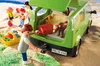 A family packing a green van for a trip to the beach, with a dog inside the van. Podgląd zdjęcia produktu