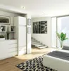 A modern bedroom interior with white furniture and a black and white rug. Produktbild-Vorschau