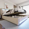 A bedroom with a bed that has its storage compartment open, revealing stored items. The bed has LED lighting. Náhľad obrázku produktu