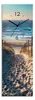 A path leading to a beach with the ocean in the background, featuring a clock face overlaid on the scene. Produktbild-Vorschau