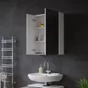 A modern bathroom with a sink, faucet, soap dispenser, and a wall-mounted cabinet with its doors open. Náhled obrázku produktu
