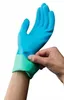 A person is putting on a blue and green glove. Náhľad obrázku produktu