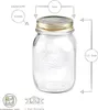 A clear glass jar with a gold lid, featuring measurement indicators and text labels. Produktbild-Vorschau