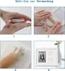 A collage of four images showing the steps to create a pet paw print impression and a framed photo of a pet. Produktbild-Vorschau