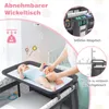 A baby on a changing table with a person changing the baby's diaper. There are callouts highlighting features of the product. Anteprima dell’immagine prodotto