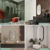 A collage of four different interior design scenes showcasing an oval mirror with integrated lighting in various settings: a hallway, a bedroom, a living room, and a bathroom. Produktbild-Vorschau