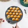 A takoyaki maker with 18 balls being cooked, with a fork in the foreground. Náhled obrázku produktu