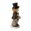 A side view of a ceramic figurine of a chimney sweep holding a pig and a four-leaf clover. Produktbild-Vorschau