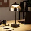 A desk with a lamp, laptop, headphones, glasses, and a notebook. Produktbild-Vorschau