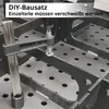 A close-up view of a welding table with a clamp holding two metal pieces together, preparing them for welding. Náhľad obrázku produktu