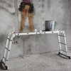 A person stands on a multi-purpose ladder in a room with concrete walls and floor. Náhľad obrázku produktu