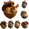 A collage of various woodland animal ornaments, each nestled inside a decorative acorn. Produktbild-Vorschau