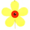 A yellow flower-shaped suncatcher with a red center and a silver screw is shown against a white background. Produktbild-Vorschau