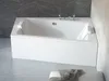 A white corner bathtub with a modern design, set in a bathroom with gray tiled walls and light gray tiled floor. A folded gray towel is visible on a white ottoman in the foreground. Produktbild-Vorschau