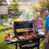 A family is having a barbecue in a backyard. Anteprima dell’immagine prodotto