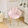 A pink upholstered chair with gold legs in a well-lit room, next to a vanity. Produktbild-Vorschau