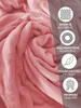 A close-up of a pink plush blanket with marketing icons and text on the right side. Produktbild-Vorschau