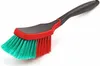 A cleaning brush with a black handle and a red and teal brush head, isolated on a white background. Produktbild-Vorschau
