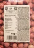A close-up of a bag of raspberry yogurt balls with white chocolate, showing the nutritional information and ingredients label. Produktbild-Vorschau