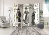A room with a decorative screen featuring vintage fashion illustrations. Produktbild-Vorschau