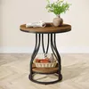 A round side table with two shelves, decorated with a book, a vase with greenery, and a basket with decorative items. Produktbild-Vorschau