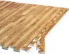 A close-up, angled view of interlocking foam floor mats with a wood-grain pattern. Náhľad obrázku produktu