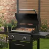 A black gas grill with food cooking on it, set in an outdoor backyard setting with a brick wall and wooden fence. Podgląd zdjęcia produktu